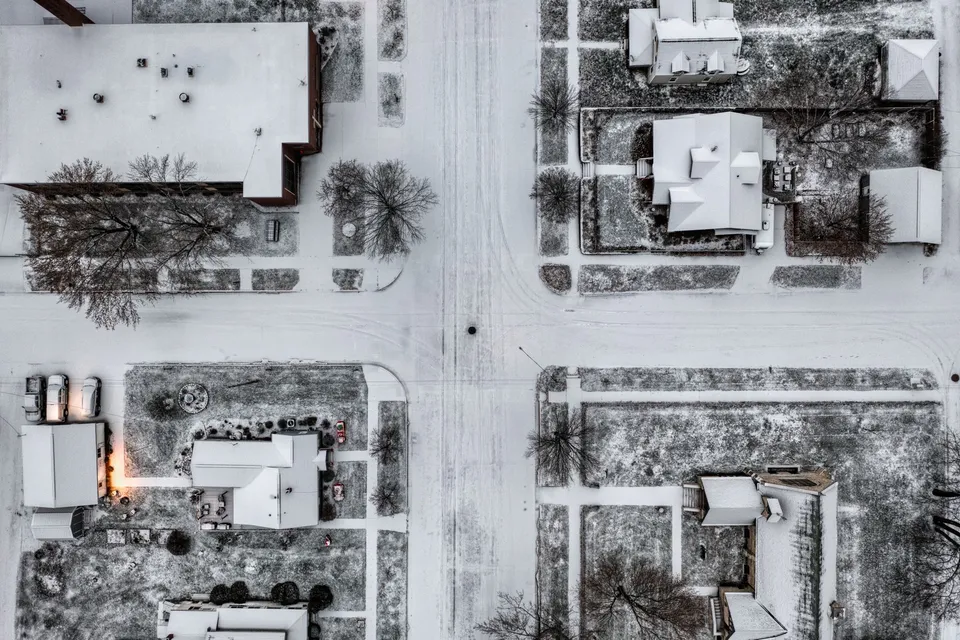 Aerial drone shot of a snowy intersection in Wabasha, Minnesota during winter.